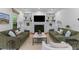 Bright living room with built-in shelving, a fireplace, and comfortable seating arrangement at 2 Pagett St, Daniel Island, SC 29492