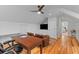 Bright home office features wooden floors, large desk, and built in shelving at 2 Pagett St, Daniel Island, SC 29492