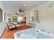 Screened porch with jacuzzi, ceiling fans, and comfortable seating with a pass through to the kitchen at 2 Pagett St, Daniel Island, SC 29492