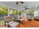 Relaxing screened patio with comfortable seating and a ceiling fan at 2 Pagett St, Daniel Island, SC 29492
