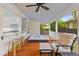 Relaxing outdoor patio featuring a hot tub, bar seating, and view into the kitchen at 2 Pagett St, Daniel Island, SC 29492