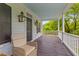 Relaxing front porch area with rocking chairs, dark wood floors and tranquil outdoor views at 2 Pagett St, Daniel Island, SC 29492