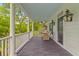 Inviting front porch with rocking chairs, dark wood floors and a light blue ceiling at 2 Pagett St, Daniel Island, SC 29492