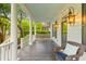 Inviting porch with a comfortable wicker chair and a view of the beautifully landscaped neighborhood at 2 Pagett St, Daniel Island, SC 29492