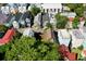 Aerial view of a residential neighborhood featuring colorful houses and lush trees at 20 Felix St, Charleston, SC 29403