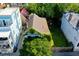 An aerial view shows the dilapidated house surrounded by colorful neighboring properties at 20 Felix St, Charleston, SC 29403