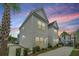 Charming two-story home featuring a well-manicured lawn, private driveway, and beautifully landscaped yard at 2009 E Patterson Pt, Hanahan, SC 29410