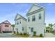 Charming two-story homes with blue and red doors and white siding showcase a modern and inviting aesthetic at 2009 E Patterson Pt, Hanahan, SC 29410