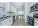 Modern kitchen featuring white cabinets, stainless steel appliances, and granite countertops at 2009 E Patterson Pt, Hanahan, SC 29410