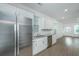 Bright kitchen boasts stainless steel appliances, granite countertops, white cabinets, and hardwood floors at 2009 E Patterson Pt, Hanahan, SC 29410