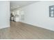 Spacious open-concept living room with vinyl flooring adjacent to the bright, modern kitchen at 2009 E Patterson Pt, Hanahan, SC 29410