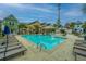 Community pool surrounded by lounge chairs and palm trees, offering a relaxing and resort-like atmosphere at 2009 E Patterson Pt, Hanahan, SC 29410
