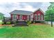 Home's exterior with deck and steps leading to the backyard and black steel fence at 208 Molasses Mill Ct, Summerville, SC 29485