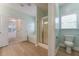 Bathroom featuring a soaking tub, glass-enclosed shower and wood look flooring at 208 Molasses Mill Ct, Summerville, SC 29485