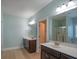 Bathroom with double vanities, wood look floors, and a glass-enclosed shower at 208 Molasses Mill Ct, Summerville, SC 29485
