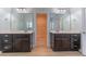 Bathroom with double vanities, wood look floors and large mirrors at 208 Molasses Mill Ct, Summerville, SC 29485