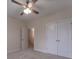 Cozy bedroom featuring plush carpet, neutral walls, ceiling fan and adjacent access at 208 Molasses Mill Ct, Summerville, SC 29485