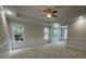Bright bedroom with tray ceiling, ceiling fan, carpet flooring, and ample windows at 208 Molasses Mill Ct, Summerville, SC 29485