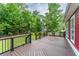 Wide deck with designer brown composite floors, black railings, and string lights overlooking the backyard at 208 Molasses Mill Ct, Summerville, SC 29485