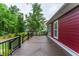 Spacious wood deck with black railings overlooking a green lawn and trees at 208 Molasses Mill Ct, Summerville, SC 29485