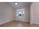 Bright dining room featuring wood floors, wainscoting, and a decorative glass front door at 208 Molasses Mill Ct, Summerville, SC 29485