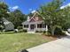 A cozy two-story home with a well-manicured lawn and classic architectural details at 208 Molasses Mill Ct, Summerville, SC 29485