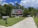 Inviting two-story home with a manicured lawn and extended driveway at 208 Molasses Mill Ct, Summerville, SC 29485