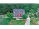 Charming two-story home featuring a well-manicured lawn, a covered porch, and a long driveway leading to the house at 208 Molasses Mill Ct, Summerville, SC 29485