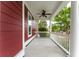 Covered front porch featuring classic white railings, siding, and a ceiling fan, perfect for enjoying the outdoors at 208 Molasses Mill Ct, Summerville, SC 29485
