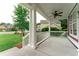 Inviting front porch featuring classic white columns, a ceiling fan, and a view of the landscaped front yard at 208 Molasses Mill Ct, Summerville, SC 29485