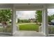Relaxing front porch with elegant white columns, offering a peaceful view of the green lawn and street at 208 Molasses Mill Ct, Summerville, SC 29485