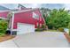 Side exterior of the house with a two-car garage and a driveway at 208 Molasses Mill Ct, Summerville, SC 29485