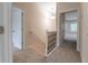 Upstairs hallway featuring neutral carpet, white trim, and access to rooms with natural light at 208 Molasses Mill Ct, Summerville, SC 29485