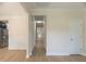 Bright hallway with wood floors, neutral walls, and views into the dining area and the stainless steel refrigerator at 208 Molasses Mill Ct, Summerville, SC 29485