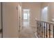 Upstairs hallway with white trim, neutral carpet, and rooms with abundant natural light at 208 Molasses Mill Ct, Summerville, SC 29485