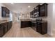Kitchen features dark cabinetry, granite countertops, subway tile backsplash, and stainless appliances at 208 Molasses Mill Ct, Summerville, SC 29485