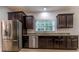 Kitchen with stainless steel appliances, dark wood cabinets and granite countertops at 208 Molasses Mill Ct, Summerville, SC 29485