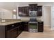 Spacious kitchen with stainless steel oven, granite countertops and dark wooden cabinets at 208 Molasses Mill Ct, Summerville, SC 29485
