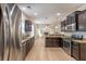Modern kitchen features stainless steel appliances, granite countertops, and dark cabinetry at 208 Molasses Mill Ct, Summerville, SC 29485
