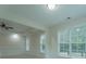 Bright living room with white trim, ceiling fan, and large windows overlooking the outdoor landscaping at 208 Molasses Mill Ct, Summerville, SC 29485