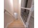 Staircase with carpet treads and black iron railing leading downstairs at 208 Molasses Mill Ct, Summerville, SC 29485