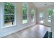Bright sunroom with hardwood floors, large windows, and a backyard view at 208 Molasses Mill Ct, Summerville, SC 29485