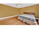 Bedroom with hardwood floors, ceiling fan, and a window with a decorative curtain at 210 Padgett Loop, Walterboro, SC 29488
