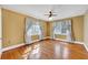Bedroom featuring hardwood floors, a ceiling fan, two windows and yellow colored walls at 210 Padgett Loop, Walterboro, SC 29488
