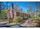 Side view of a brick home with manicured shrubs and a walkway leading to the entrance at 210 Padgett Loop, Walterboro, SC 29488
