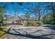 Exterior view of home showcasing long driveway, brick exterior, and mature landscaping at 210 Padgett Loop, Walterboro, SC 29488