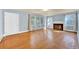 Spacious living room featuring hardwood floors, a cozy fireplace, and ample natural light at 210 Padgett Loop, Walterboro, SC 29488