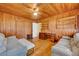 Cozy living room featuring knotty pine walls, hardwood floors, and comfortable seating at 210 Padgett Loop, Walterboro, SC 29488