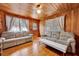 Cozy living room with knotty pine walls, hardwood floors, and comfortable seating at 210 Padgett Loop, Walterboro, SC 29488