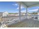 Spacious balcony with white railings and columns, offering views of the neighborhood and a sunny sky at 213 Clearpath Dr, Summerville, SC 29486